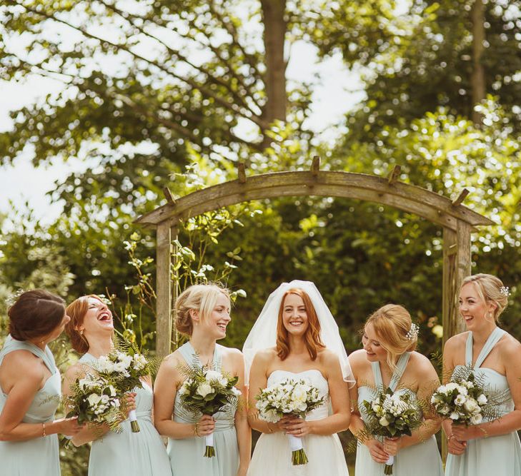 Bride in Stewart Parving Gown & Bridesmaids in Pastel Monsoon Dresses