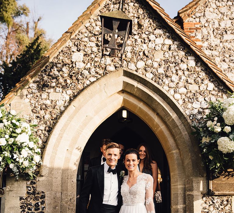 Bride in Camellia Suzanne Neville Gown & Groom in SuitSupply Tuxedo