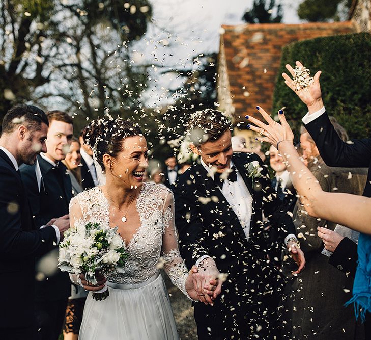 onfetti Moment with Bride in Camellia Suzanne Neville Gown & Groom in SuitSupply Tuxedo