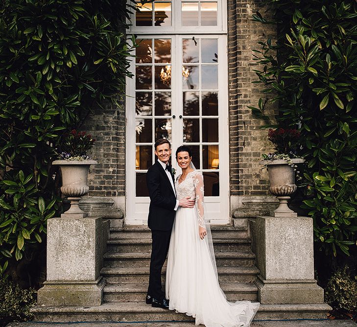 Bride in Camellia Suzanne Neville Gown & Groom in SuitSupply Tuxedo