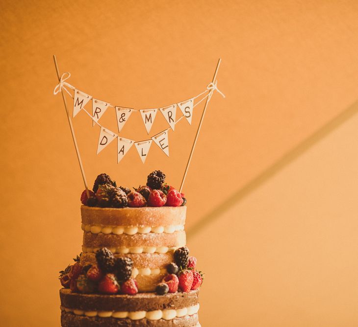 Naked Sponge Wedding Cake with Mini Bunting Topper | PapaKåta Tipi at Angrove Park North Yorkshire | Matt Penberthy Photography