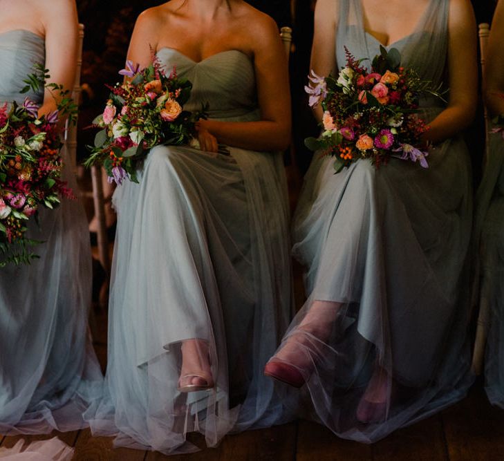 Bridesmaids in Blue Jenny Yoo Chiffon Dresses | Red Bouquets | Woodland Themed Wedding at Achnagairn Estate near Inverness, Scotland | Zoe Alexander Photography