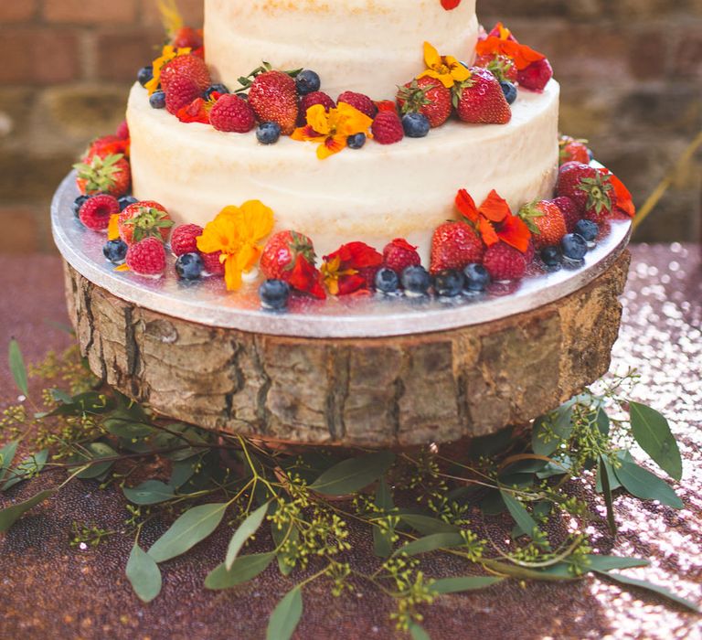 Semi Naked Wedding Cake Laden With Fruit on Rustic Tree Slice Cake Stand | Kirsty Mackenzie Photography | Insta Wedding Films