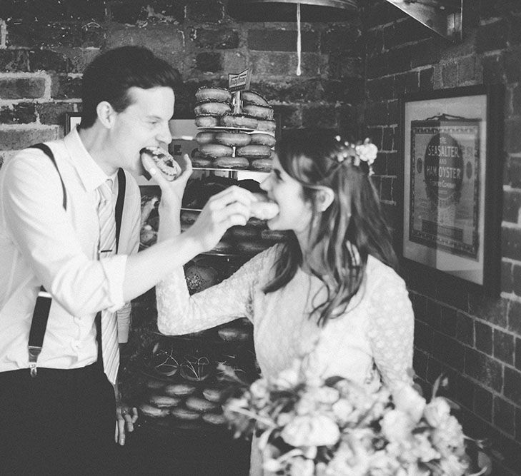 Bride & Groom Eating Krispy Kreme Wedding Doughnuts | Bright Coastal Wedding at East Quay Venue in Whitstable | Deborah Grace Photography