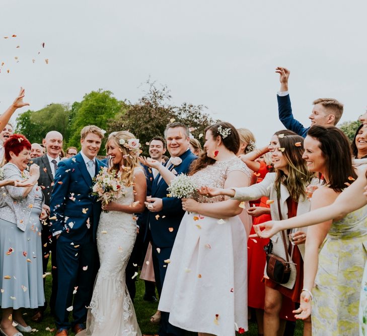 Confetti Moment | Bride in Lace Lillian West Wedding Dress | Groom in T.M Lewin Navy Suit | Benjamin Stuart Photography