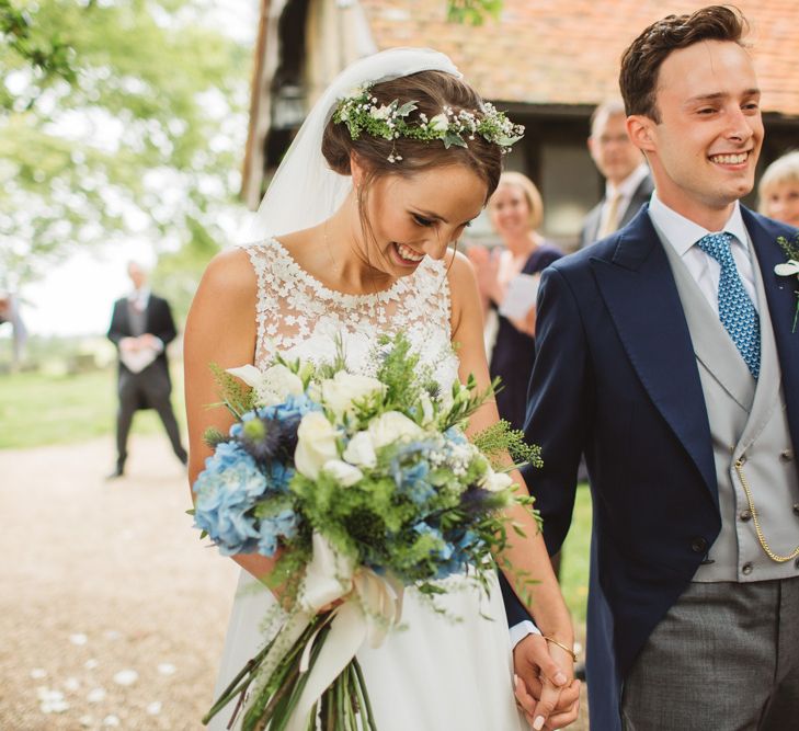 Bride in Lace Bodice & Ingrida Bridal Wedding Dress with Blue & White Hydrangea & Stock Bouquet and Groom in Traditional Morning Suit