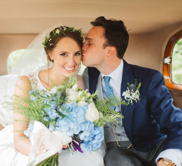 Bride in Lace Bodice & Ingrida Bridal Wedding Dress with Blue & White Hydrangea & Stock Bouquet and Groom in Traditional Morning Suit