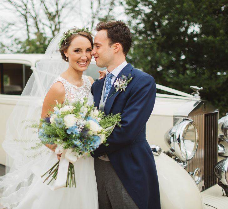 Bride in Lace Bodice & Ingrida Bridal Wedding Dress with Blue & White Hydrangea & Stock Bouquet and Groom in Traditional Morning Suit