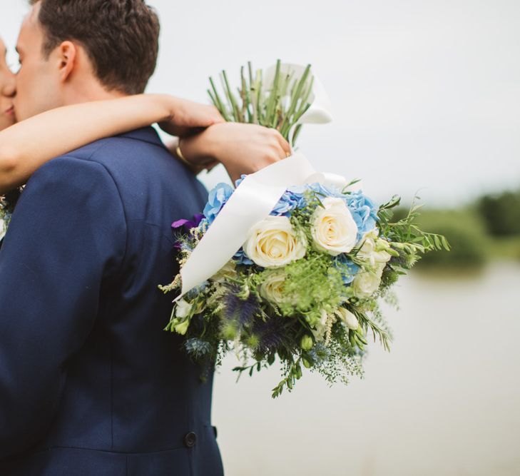 Bride in Lace Bodice & Ingrida Bridal Wedding Dress with Blue & White Hydrangea & Stock Bouquet and Groom in Traditional Morning Suit