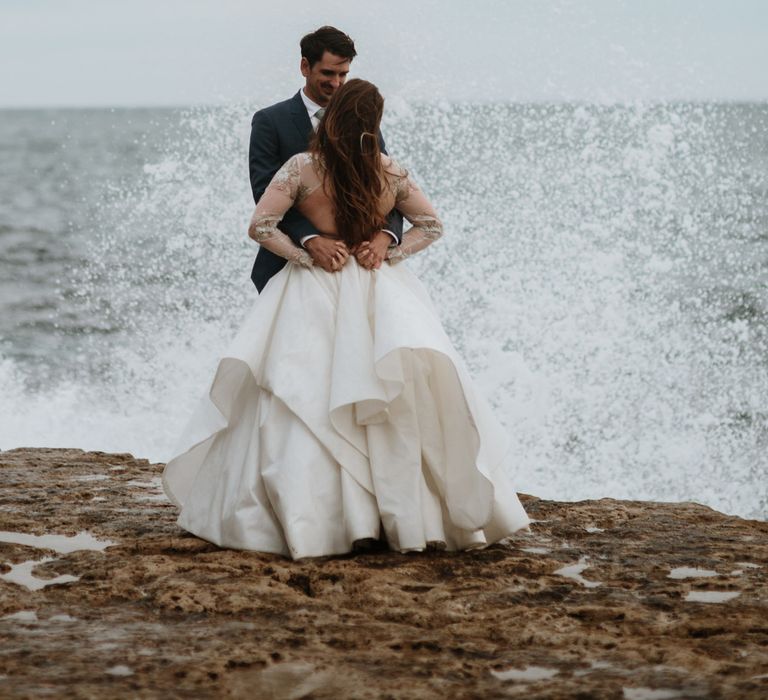 After Wedding Portraits at Portland Bill, Dorset | Bride in Miss Hayley Paige Bridal Gown | Groom in Navy Ted Baker Suit | Green Antlers Photography | Gione Da Silva Film