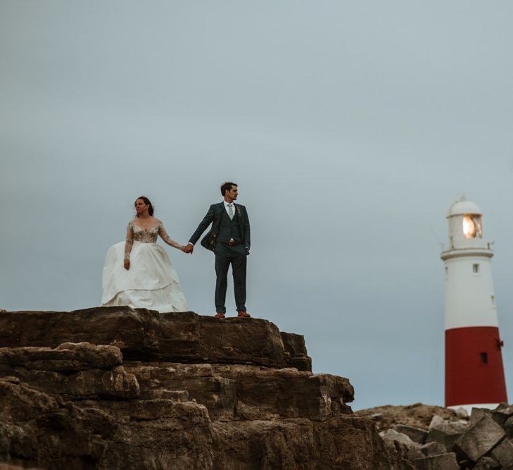 After Wedding Portraits at Portland Bill, Dorset | Bride in Miss Hayley Paige Bridal Gown | Groom in Navy Ted Baker Suit | Green Antlers Photography | Gione Da Silva Film