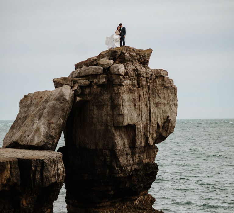 After Wedding Portraits at Portland Bill, Dorset | Bride in Miss Hayley Paige Bridal Gown | Groom in Navy Ted Baker Suit | Green Antlers Photography | Gione Da Silva Film