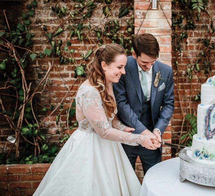 Cutting the Geode Wedding Cake | Bride in Miss Hayley Paige Bridal Gown | Groom in Navy Ted Baker Suit | Natural Wedding at Northbrook Park, Surrey | Green Antlers Photography | Gione Da Silva Film