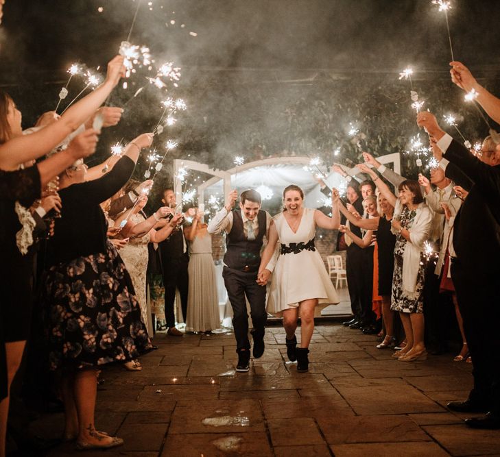 Sparkler Exit | Bride in Miss Hayley Paige Bridal Gown | Groom in Navy Ted Baker Suit | Natural Wedding at Northbrook Park, Surrey | Green Antlers Photography | Gione Da Silva Film