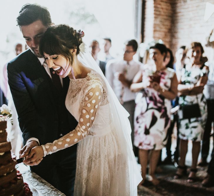 Cutting The Cake | Bride in Katya Katya Gown | Groom in Ted Baker Suit | Fishley Hall Rustic Barn Wedding | Darina Stoda Photography