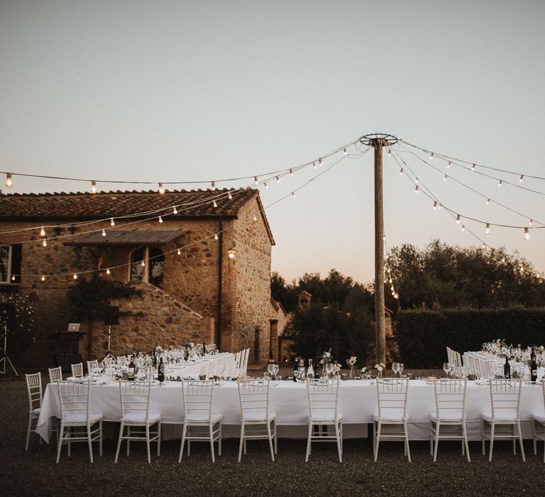 Festoon Lit Wedding Breakfast In Italy // Elegant Destination Wedding In Tuscany At San Galgano Abbey With Bride In Bespoke Dress By Madame Paulette With Images From James Frost Photography