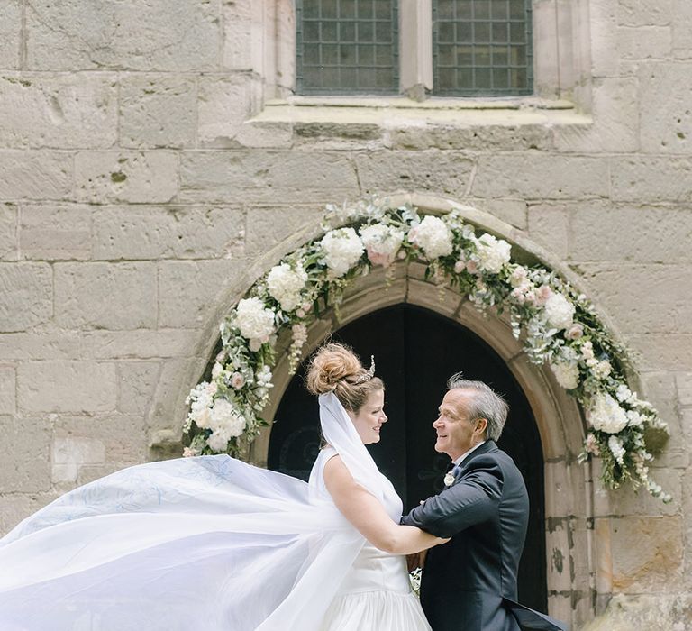 Bridal Entrance | Floral Arch | Classic Blue & White Wedding at Prestwold Hall in Loughborough | Georgina Harrison Photography