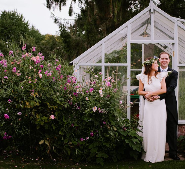 Bride & Groom Glasshouse Portrait | Bright Festival Themed At Home Wedding in a Tipi | McGivern Photography