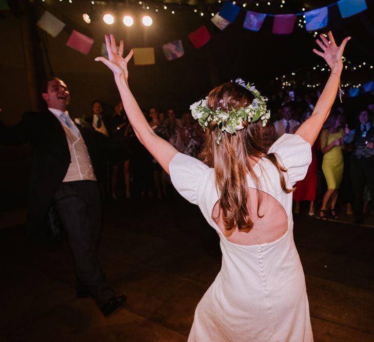 Bride in Open Back Gown From The Mews Bridal with Flower Crown | Bright Festival Themed At Home Wedding in a Tipi | McGivern Photography