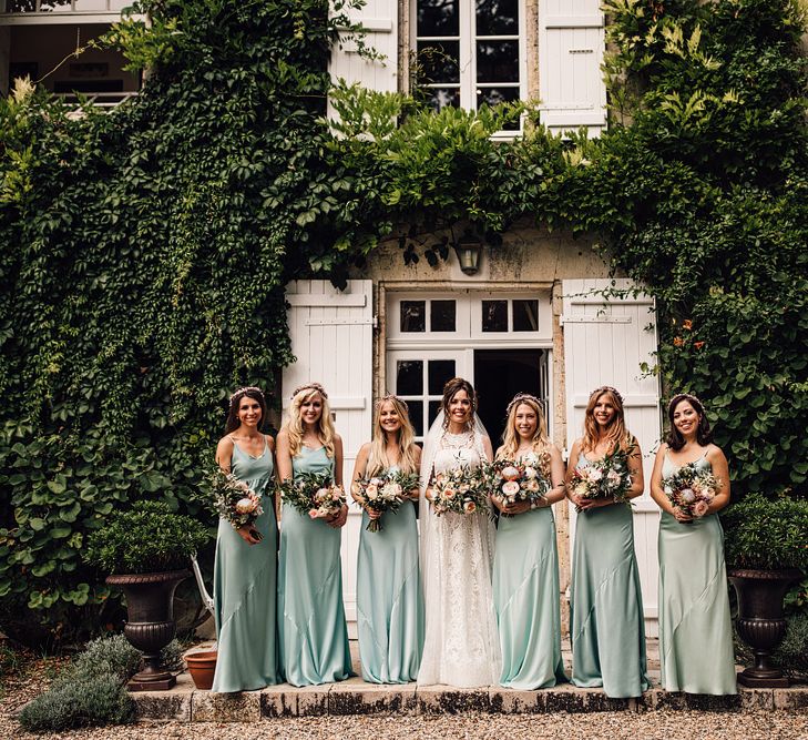 Bridesmaids in Mint Green Dresses | Bride in Lace Yolan Cris Gown | Outdoor Destination Wedding at Château De Malliac Planned by Country Weddings in France | Styling by The Hand-Painted Bride | Samuel Docker Photography | Marriage in Motion Films