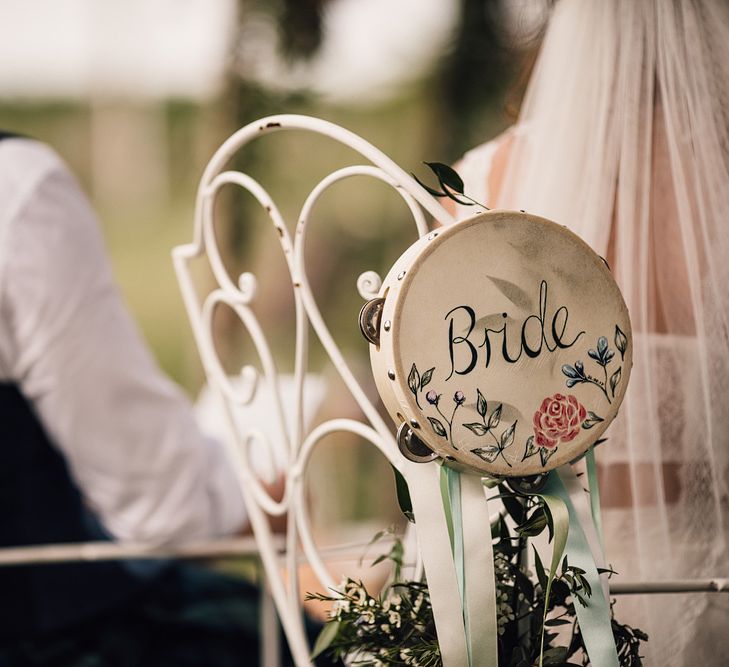 Hand Painted Tamborine | Wedding Ceremony | Bride in Lace Yolan Cris Gown | Groom in Tartan Kilt | Outdoor Destination Wedding at Château De Malliac Planned by Country Weddings in France | Styling by The Hand-Painted Bride | Samuel Docker Photography | Marriage in Motion Films