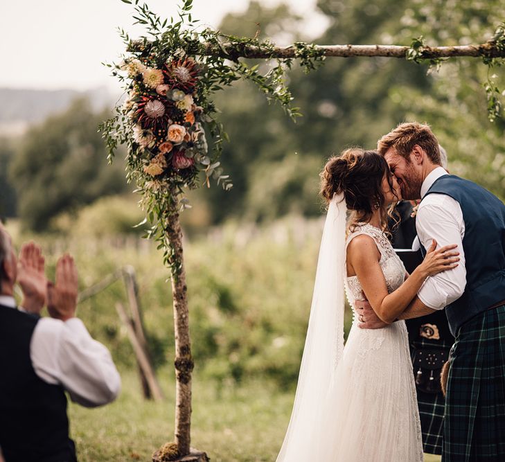 Wedding Ceremony | Bride in Lace Yolan Cris Gown | Groom in Tartan Kilt | Outdoor Destination Wedding at Château De Malliac Planned by Country Weddings in France | Styling by The Hand-Painted Bride | Samuel Docker Photography | Marriage in Motion Films