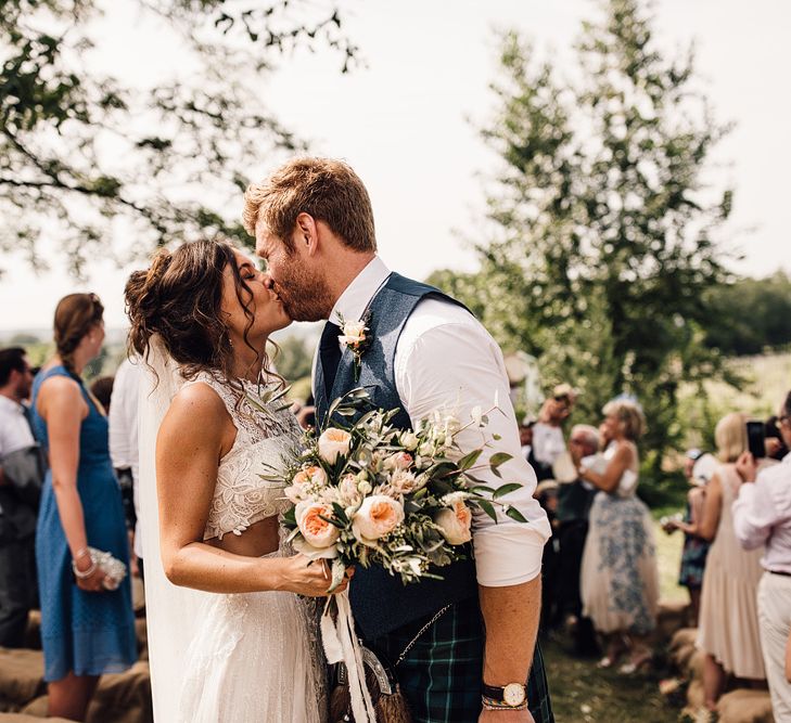 Wedding Ceremony | Bride in Lace Yolan Cris Gown | Groom in Tartan Kilt | Outdoor Destination Wedding at Château De Malliac Planned by Country Weddings in France | Styling by The Hand-Painted Bride | Samuel Docker Photography | Marriage in Motion Films