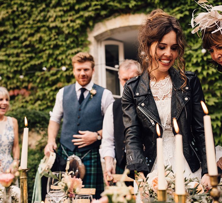 Bride in Yolan Cris Lace Gown & Leather Jacket | Groom in Tartan Kilt | Outdoor Destination Wedding at Château De Malliac Planned by Country Weddings in France | Styling by The Hand-Painted Bride | Samuel Docker Photography | Marriage in Motion Films