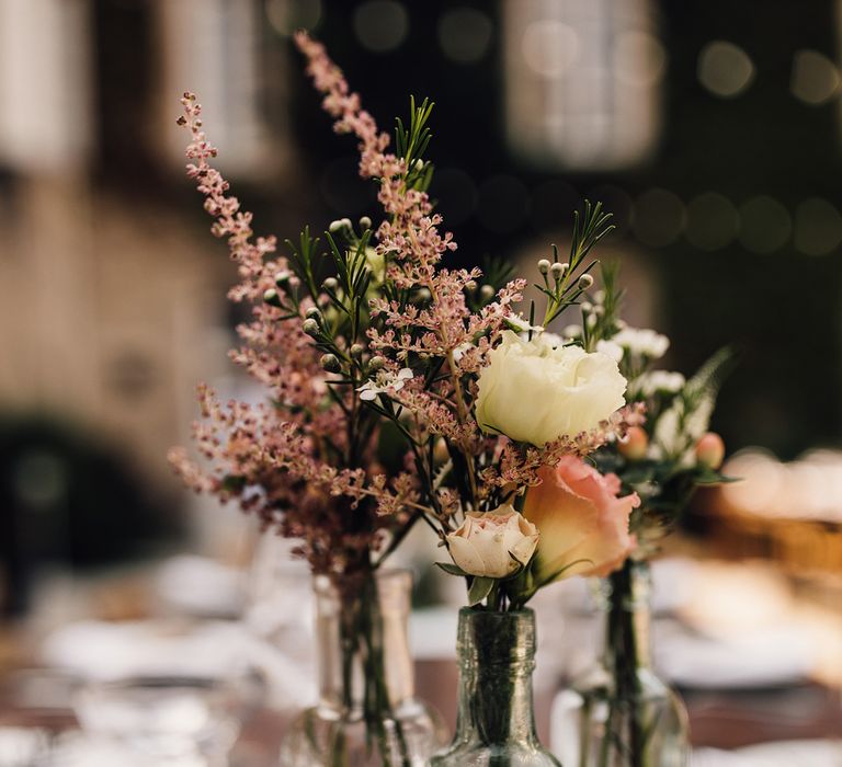 Flower Stems in Bottles Wedding Decor | Outdoor Destination Wedding at Château De Malliac Planned by Country Weddings in France | Styling by The Hand-Painted Bride | Samuel Docker Photography | Marriage in Motion Films