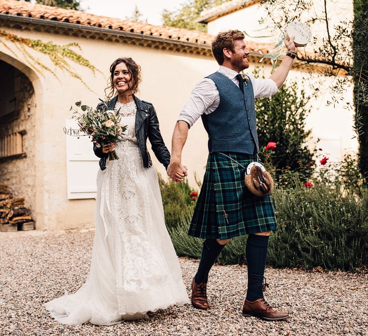 Bride in Yolan Cris Lace Gown & Leather Jacket | Groom in Tartan Kilt | Outdoor Destination Wedding at Château De Malliac Planned by Country Weddings in France | Styling by The Hand-Painted Bride | Samuel Docker Photography | Marriage in Motion Films