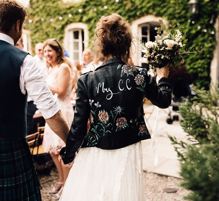 Bride in Yolan Cris Lace Gown & Leather Jacket | Outdoor Destination Wedding at Château De Malliac Planned by Country Weddings in France | Styling by The Hand-Painted Bride | Samuel Docker Photography | Marriage in Motion Films