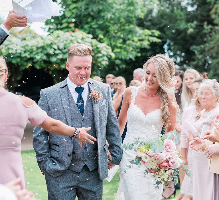 Confetti Moment | Bride in Lace Enzoani 'Inaru' Bridal Gown | Groom in Grey Wool Master Debonair Suit | Pink & Coral Country Wedding at Crabbs Barn, Essex | Kathryn Hopkins Photography | Film by Colbridge Media Services Ltd