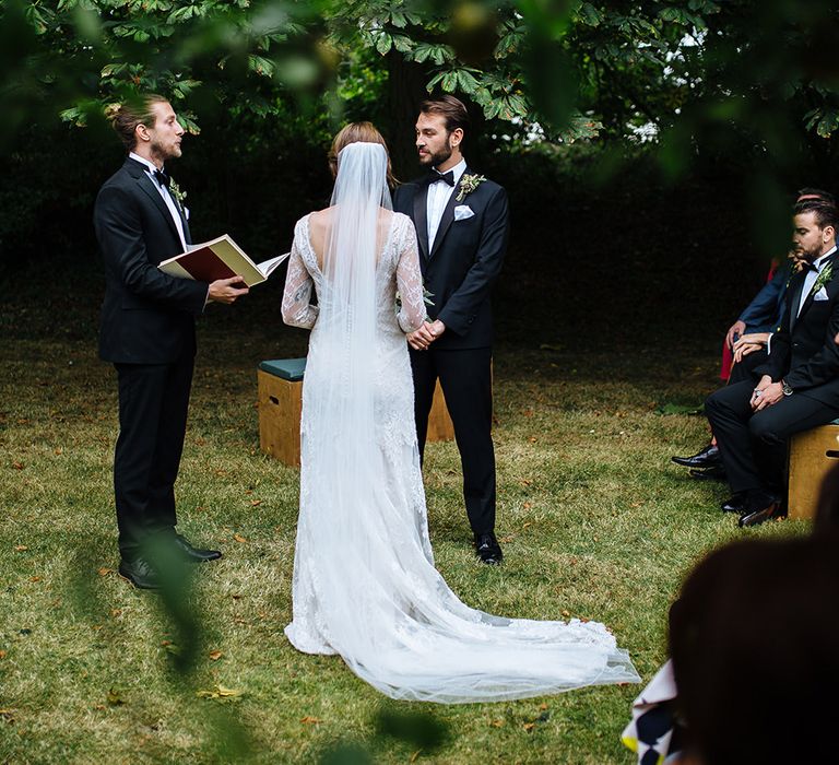 Outdoor Wedding Ceremony at Childerley Hall | Bride in Lace Sottero & Midgley Gown | Groom in Herrvon Eden Tuxedo | Tawny Photo