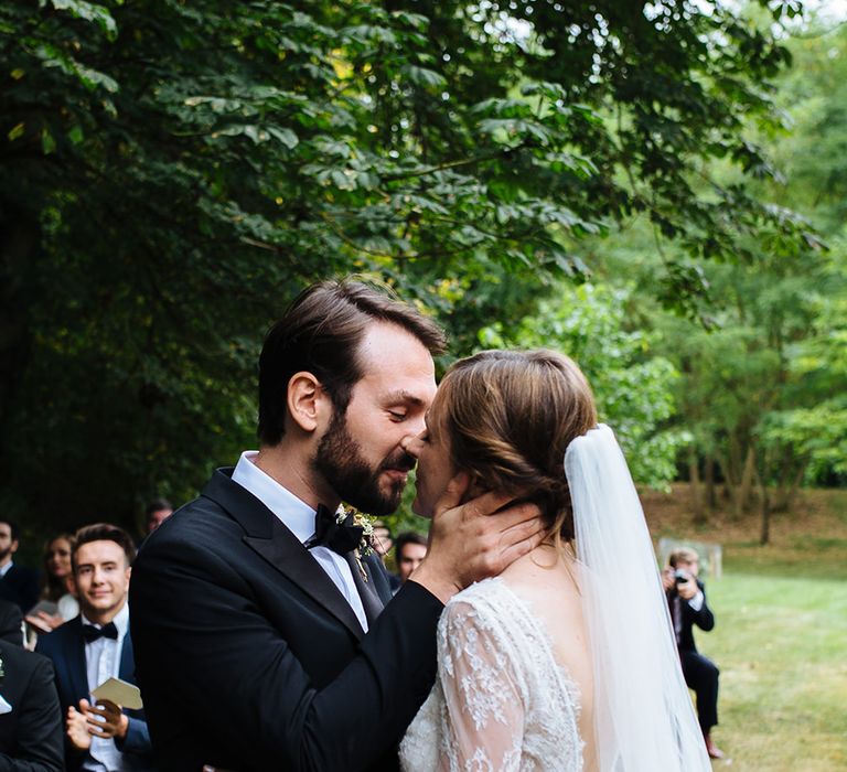 Outdoor Wedding Ceremony at Childerley Hall | Bride in Lace Sottero & Midgley Gown | Groom in Herrvon Eden Tuxedo | Tawny Photo