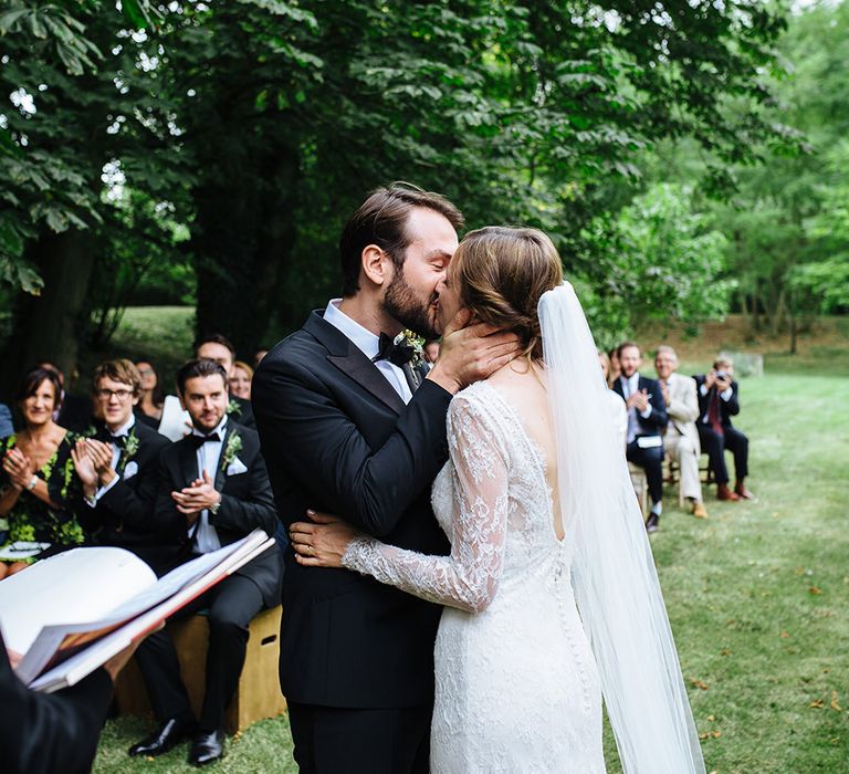 Outdoor Wedding Ceremony at Childerley Hall | Bride in Lace Sottero & Midgley Gown | Groom in Herrvon Eden Tuxedo | Tawny Photo