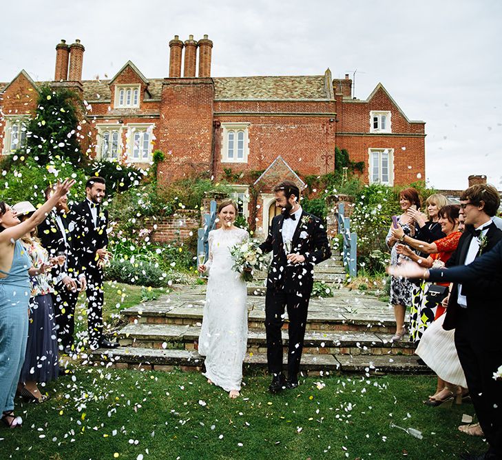 Confetti Moment | Childerley Hall Wedding | Bride in Lace Sottero & Midgley Gown | Groom in Herrvon Eden Tuxedo | Tawny Photo