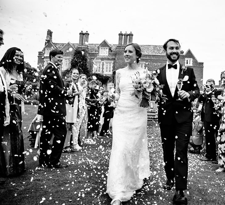 Confetti Moment | Childerley Hall Wedding | Bride in Lace Sottero & Midgley Gown | Groom in Herrvon Eden Tuxedo | Tawny Photo