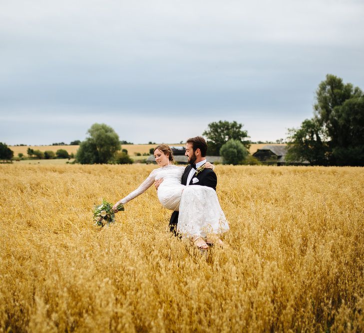 Bride in Maggie Sottero Lace Gown | Groom in Herrvon Eden Tuxedo | Tawny Photo