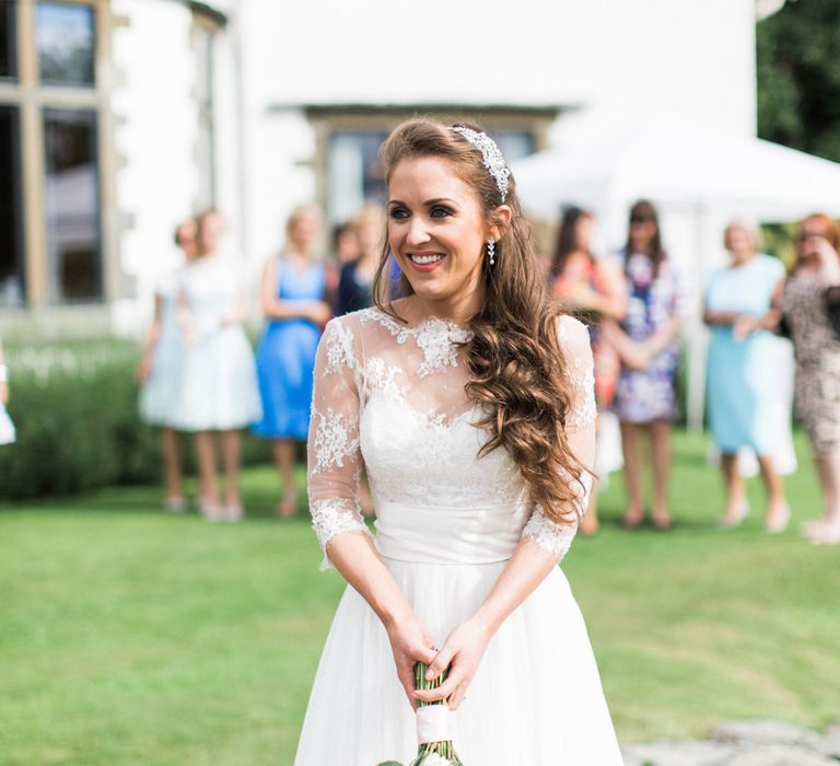 Bride in Lace Wedding Dress from Agape Bridal Boutique | Bouquet Toss