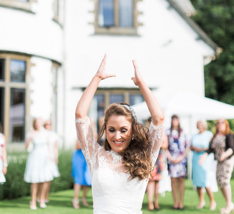 Bride in Lace Wedding Dress from Agape Bridal Boutique | Bouquet Toss