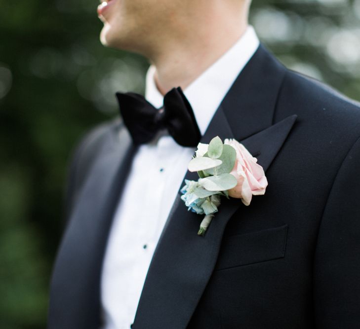 Groom in Chester Barrie Black Tie Suit with Pastel Buttonhole