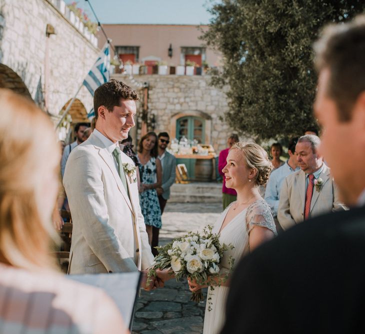 Wedding Ceremony | Bride in Catherine Deane Gown | Groom in Beige Austin Reed Suit | Outdoor Pastel Destination Wedding at Agreco in Greece | Best Moments Wedding Planner | Paulina Weddings Photography