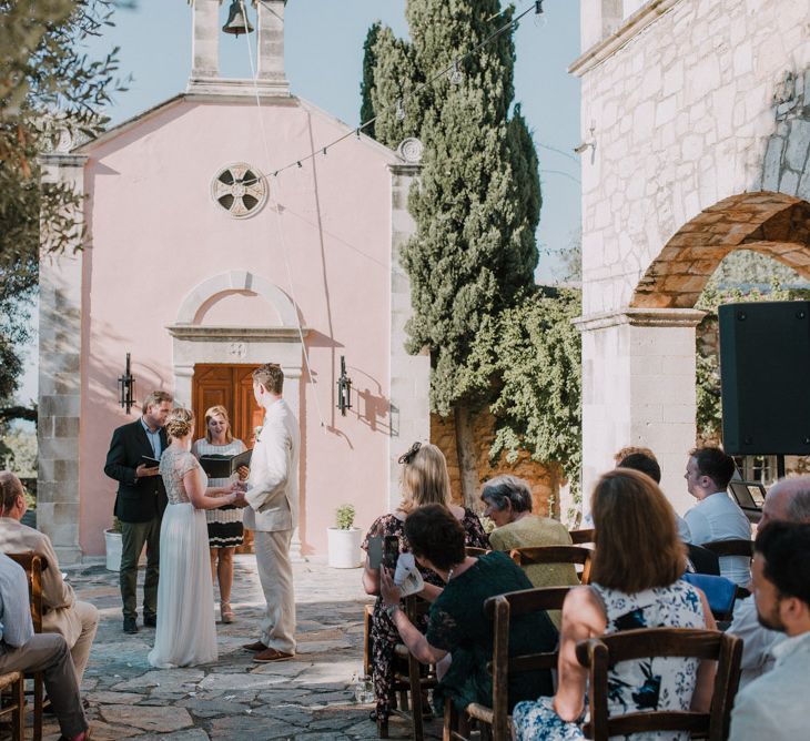 Wedding Ceremony | Bride in Catherine Deane Gown | Groom in Beige Austin Reed Suit | Outdoor Pastel Destination Wedding at Agreco in Greece | Best Moments Wedding Planner | Paulina Weddings Photography