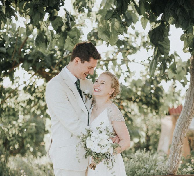 Bride in Catherine Deane Gown | Groom in Beige Austin Reed Suit | Outdoor Pastel Destination Wedding at Agreco in Greece | Best Moments Wedding Planner | Paulina Weddings Photography