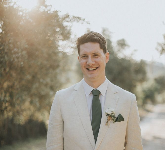 Groom in Beige Austin Reed Suit | Outdoor Pastel Destination Wedding at Agreco in Greece | Best Moments Wedding Planner | Paulina Weddings Photography