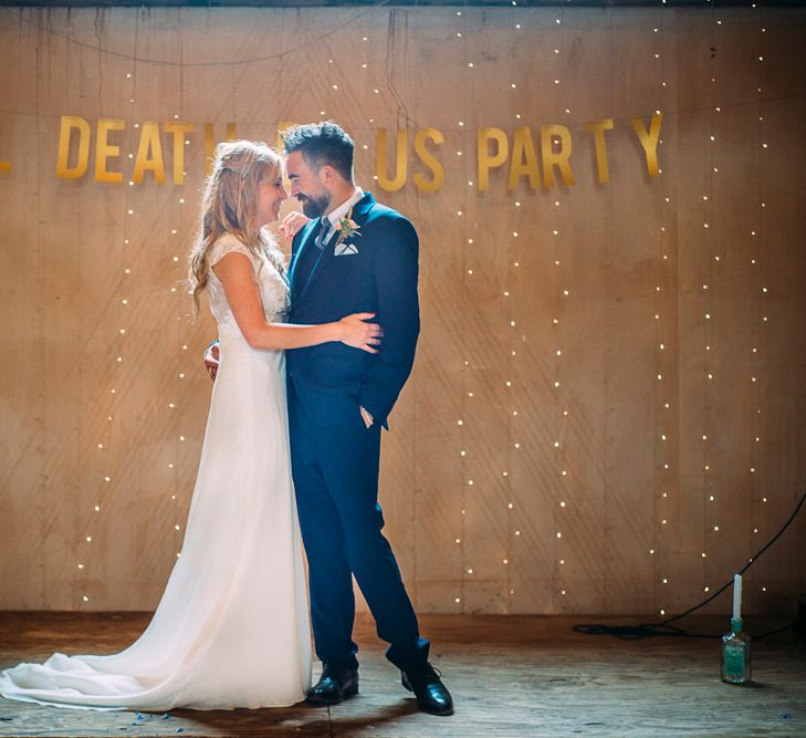 Bride in Ivy & Aster Gown | Groom in Reiss Suit | Till Death Us Do Party Banner | Rustic Wedding at Yoghurt Rooms in Sussex | Louise Griffin Photography