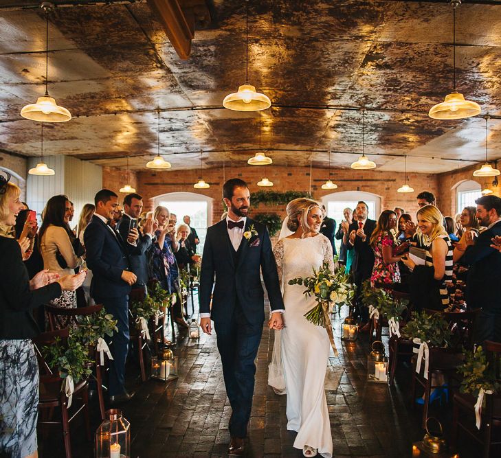 Bride in Charlie Brear Torum Dress & Adrianna Lace Jacket | Industrial Wedding Ceremony at The West Mill | Greenery Flower Arch | S6 Photography