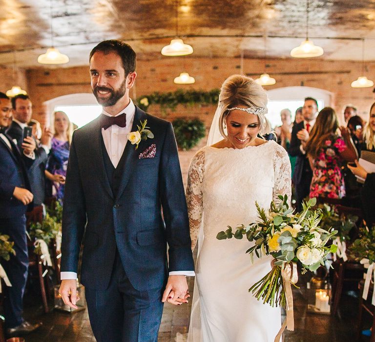 Bride in Charlie Brear Torum Dress & Adrianna Lace Jacket | Industrial Wedding Ceremony at The West Mill | Greenery Flower Arch | S6 Photography