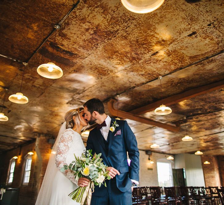 The West Mill Industrial Wedding Venue | Bride in Charlie Brear Torum Dress & Adrianna Lace Jacket | Groom in Bespoke Michelsberg Tailoring Suit & Bow Tie | S6 Photography