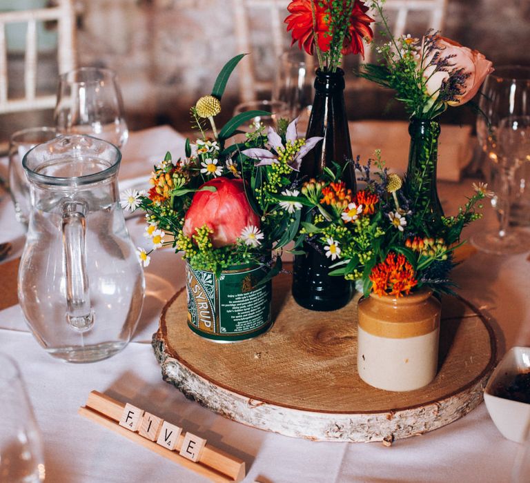 Rustic Tree Slice Centrepiece with Flower Stems in Jars & Vases